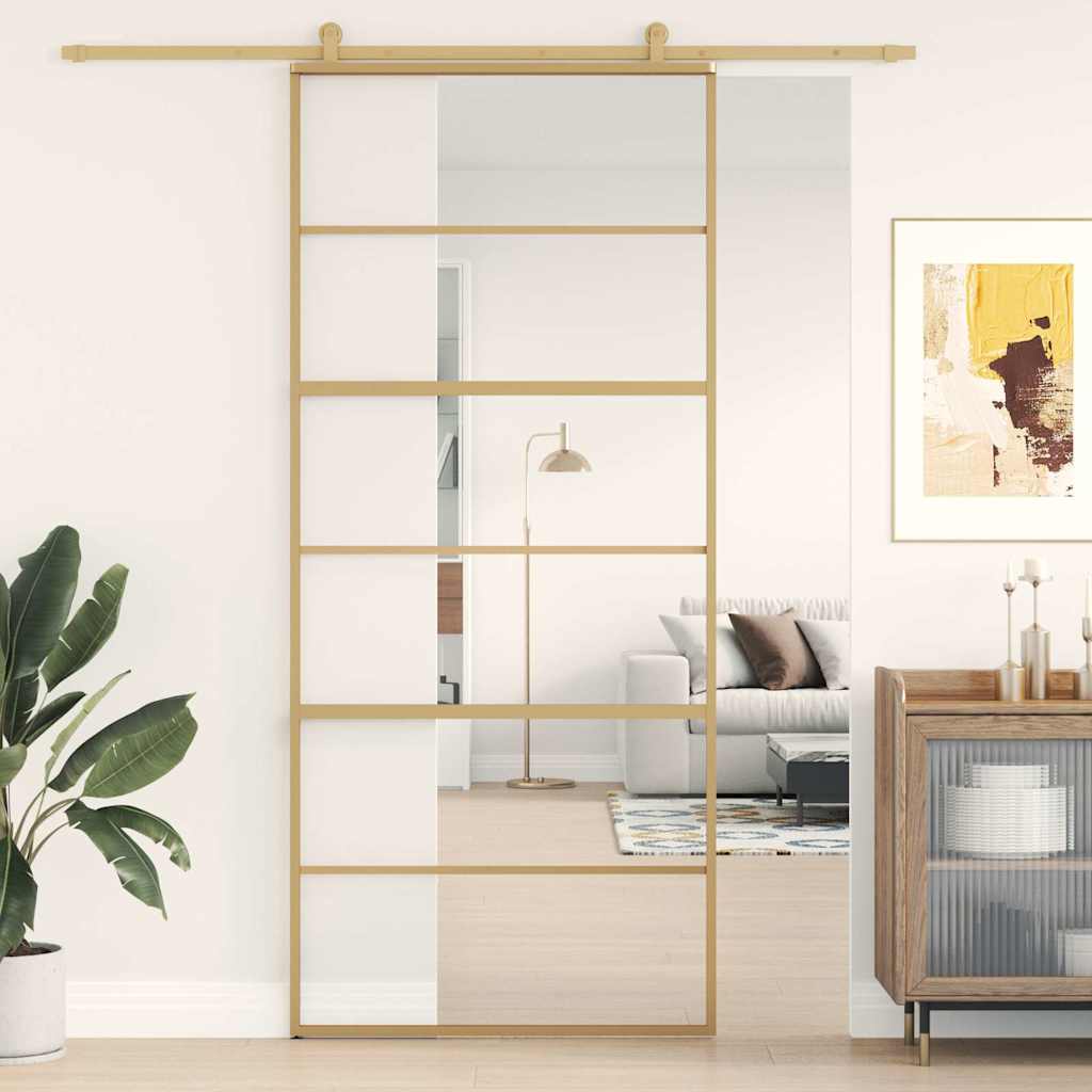 Golden sliding door of transparent ESG glass and aluminum 
