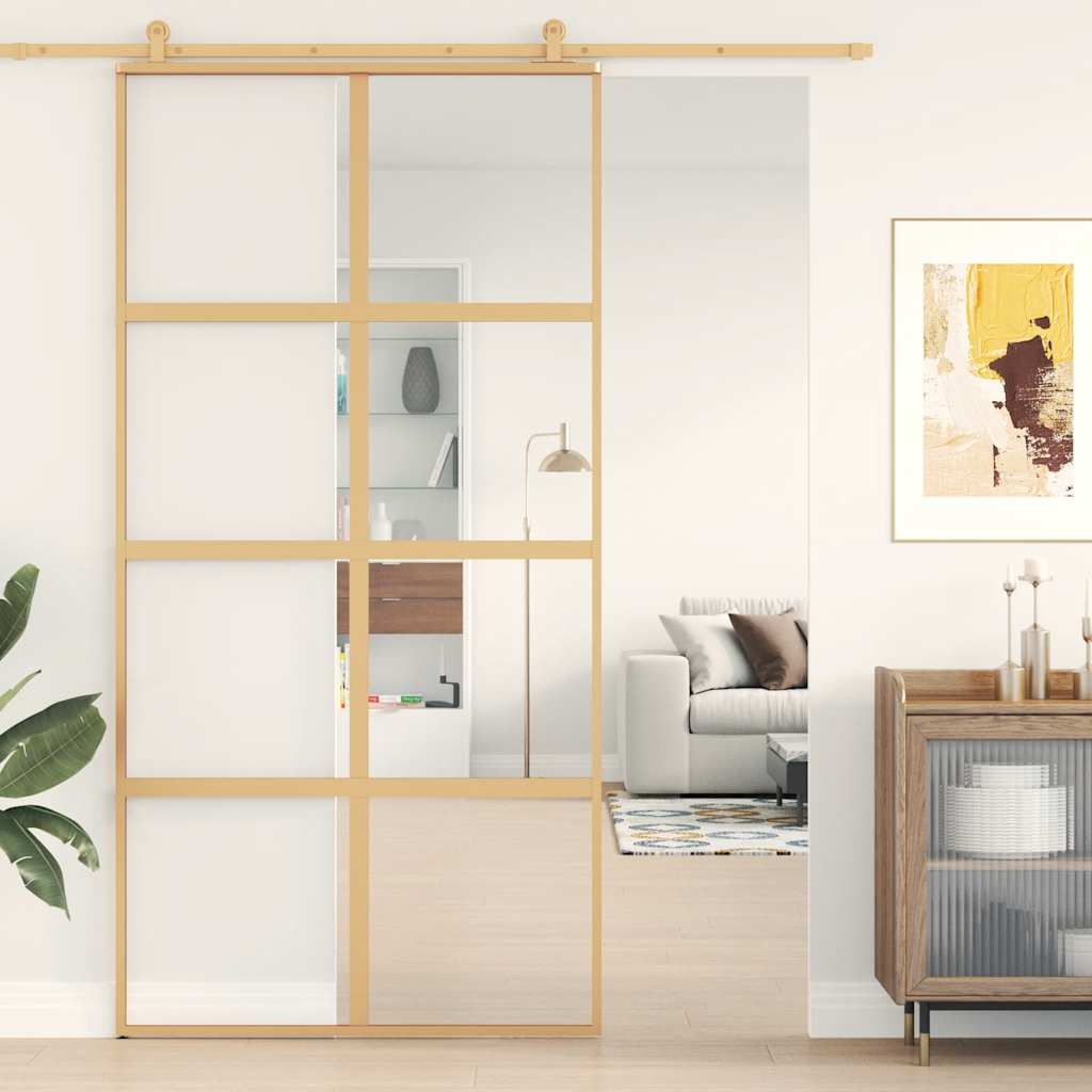 Sliding door made of transparent ESG glass and gold aluminum 