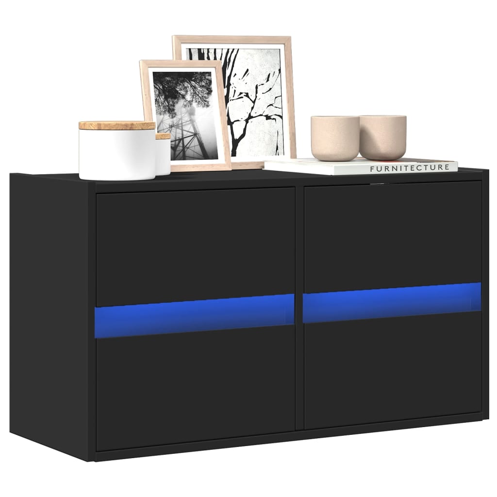 Mueble de TV de pared negro con detalles LED azul, decorado con cuadros y accesorios modernos.