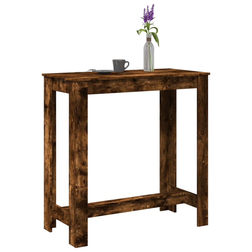 Mesa alta de bar de madera de ingeniería en roble ahumado, ideal para cocina o sala de estar, con decoración floral.