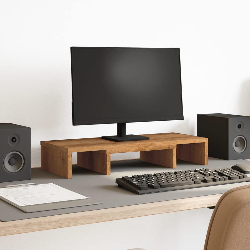 Soporte de monitor ajustable de madera de roble en un escritorio moderno con altavoces y teclado.