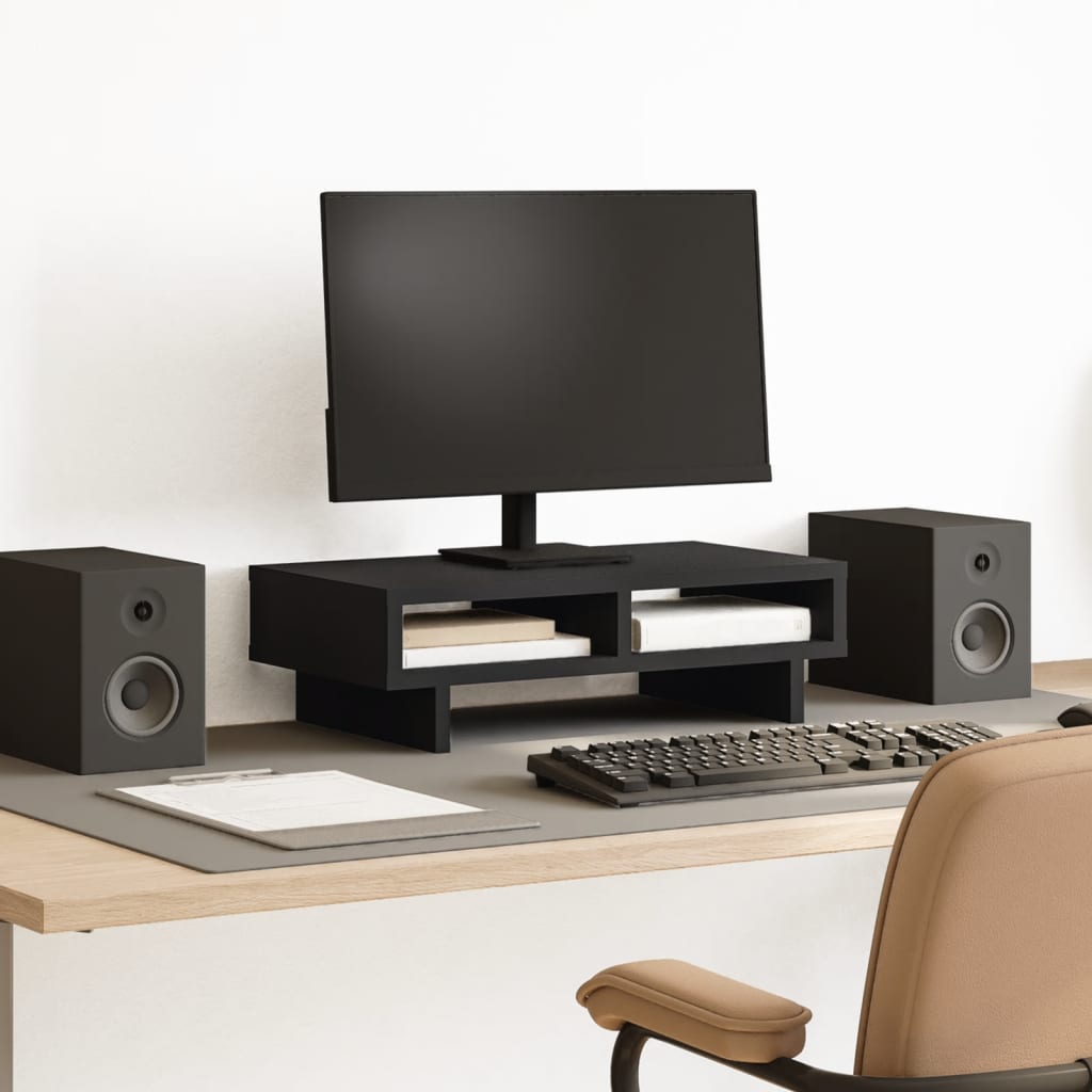 Soporte de monitor de madera negra en un escritorio moderno, con altavoces y teclado, ideal para mejorar la organización del espacio de trabajo.