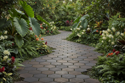 Camino de jardín pavimentado con Panot Hexagonal Laguardia Bicolor en bronce entre plantas - Vetonek